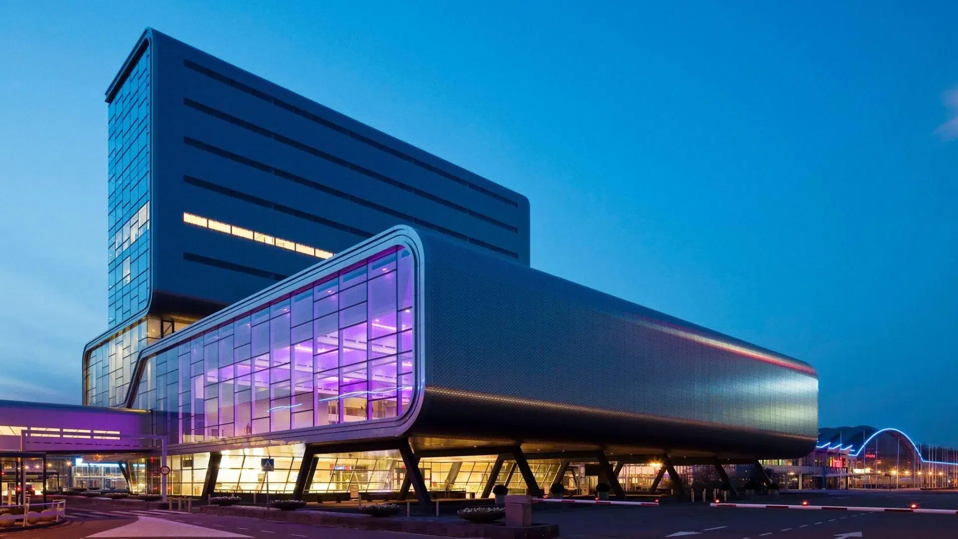 RAI Amsterdam Convention Centre illuminated at night with its bold contemporary architecture — one of Amsterdam's largest conference and event venues, and a reference point when planning large-scale corporate programmes in the city